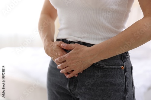 Menopause. Woman suffering from abdominal pain at home, closeup