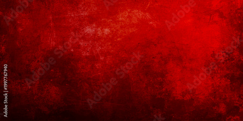 A dark distressed red grunge wall texture with a vintage aged paint pattern creates a grungy material surface for a retro christmas backdrop or old paper design