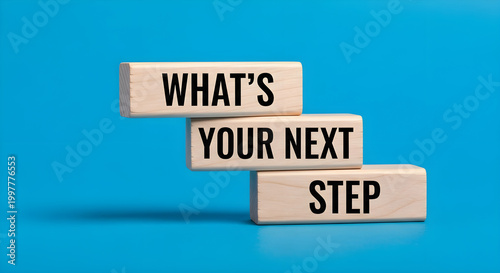 What's Your Next Step text on wooden blocks, conceptual business planning and career growth strategy, staircase of wood bricks on blue background