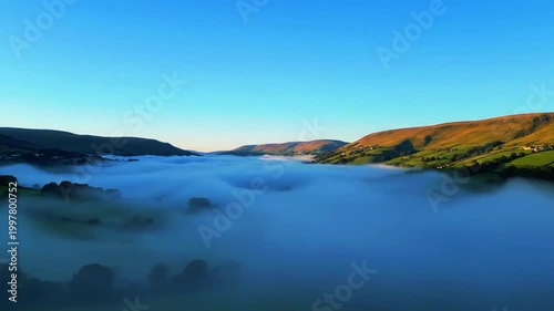  a wide shot with clear sky and drifting valley fog