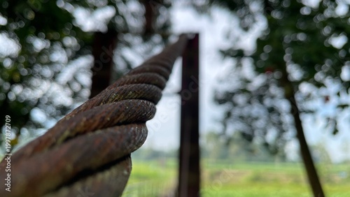 Close Up of Rusty Steel Cable Outdoors Showing Corrosion Texture and Weathered Industrial Detail