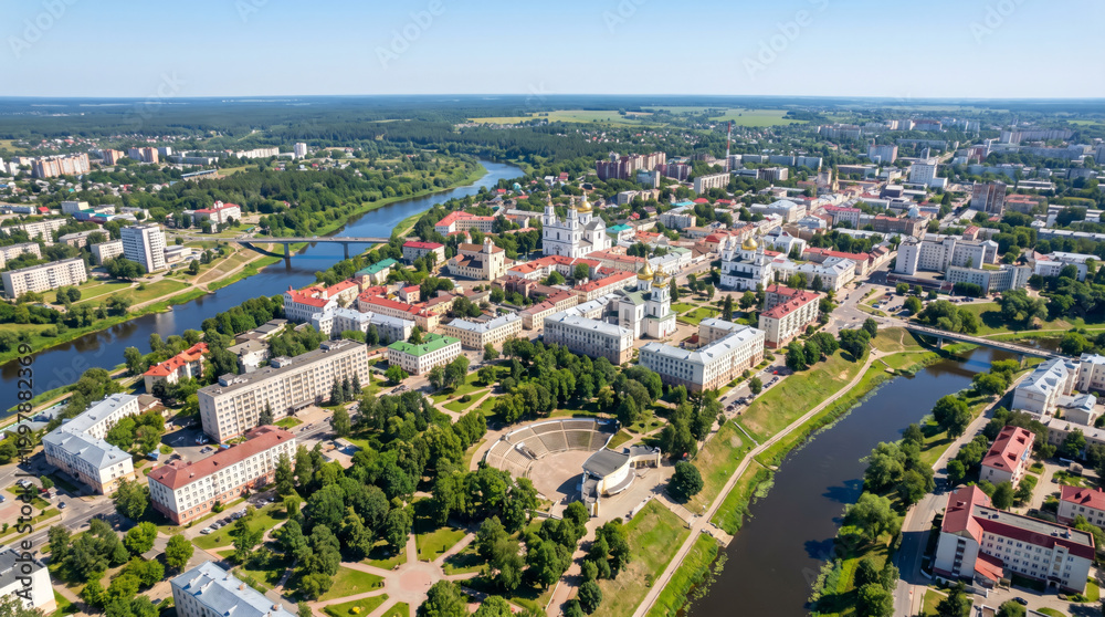 Fototapeta premium Aerial view of a European city with a river flowing through it and green parks.