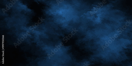 Abstract blue smoke swirls like a dark storm cloud against a black night background creating a motion texture of fog and space