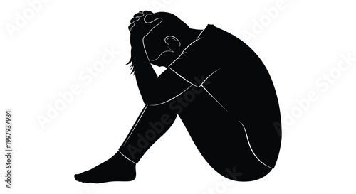 A somber figure is seated with head in hands expressing deep sorrow silhouette