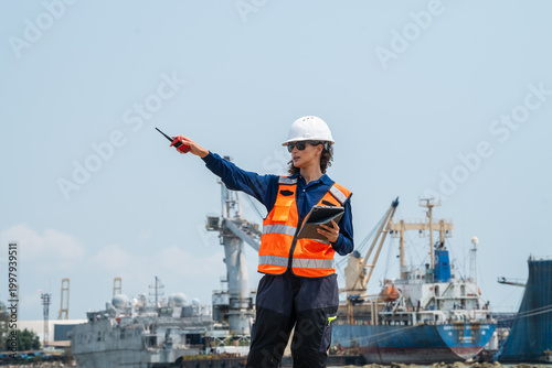 Photography Woman wears a white hard hat and orange safety vest
