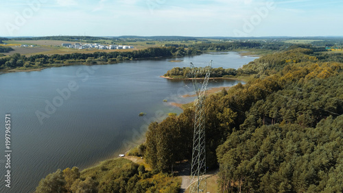 Foto High voltage lines by scenic lake