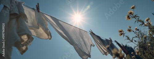 Laundry hanging on a line to dry under the sun in clear sky  
