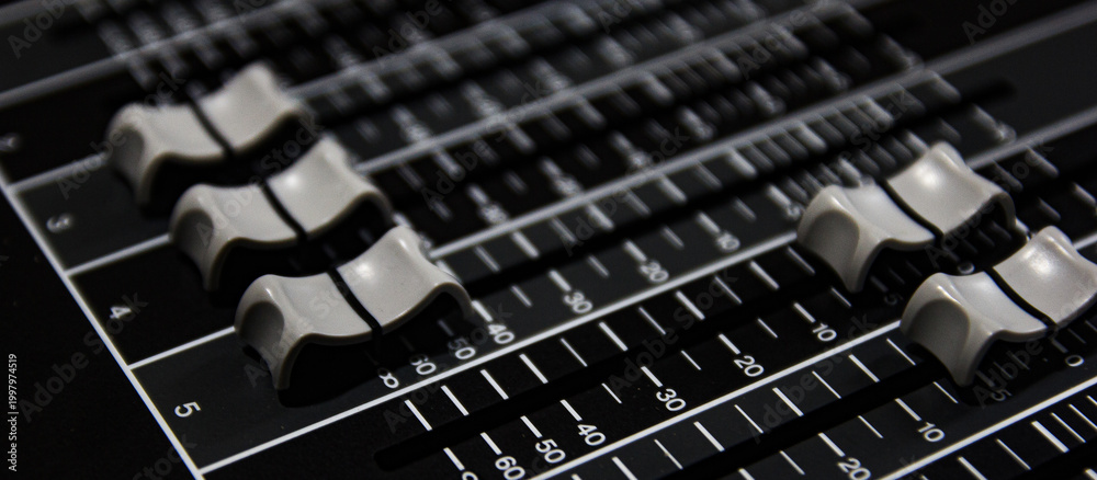 Obraz premium White volume sliders for audio mixers.