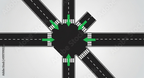 Aerial view of a complex road intersection with green arrows indicating traffic flow.