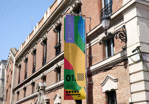 Mockup of a vertical fly banner on the facade of a building in Madrid.