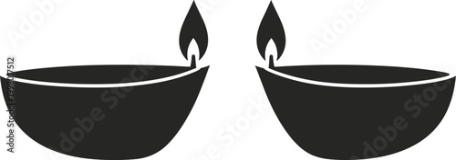 Two black silhouette oil lamps with flames