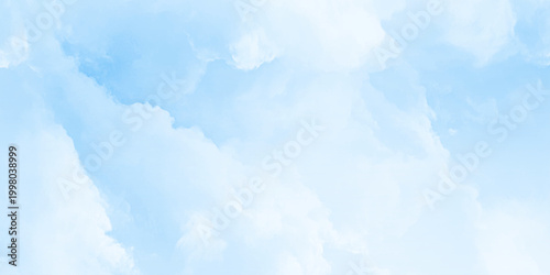 A vibrant shot of the blue sky filled with large fluffy white cumulus clouds suggesting fair weather and an open bright day