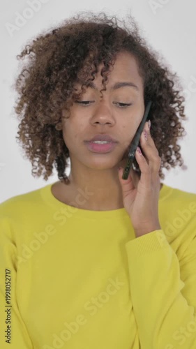 Young African Woman Talking on Phone on White Background, Vertical Video