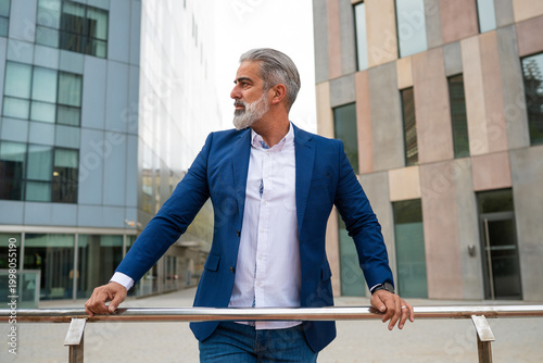 Fotografía Confident businessman standing outdoors urban achieving leadership success