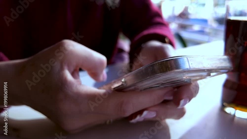 Close Up of Woman Hands Using Smartphone in Cafe, Browsing Social Media on Mobile Device 