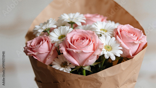 Bouquet of Pink Roses and White Daisies Wrapped in Brown Paper