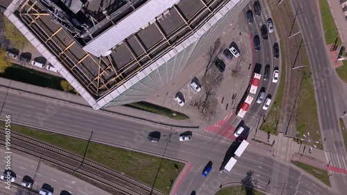 Aerial top view of urban traffic intersection with tram and cars, smart city transportation and modern urban mobility concept 