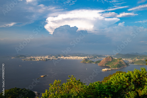 Dramatic aerial view of Guanabara Bay and mountain in Rio de Janeiro with an awe inspiring large storm cloud
