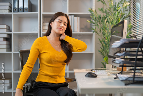 Woman experiencing neck pain due to office work