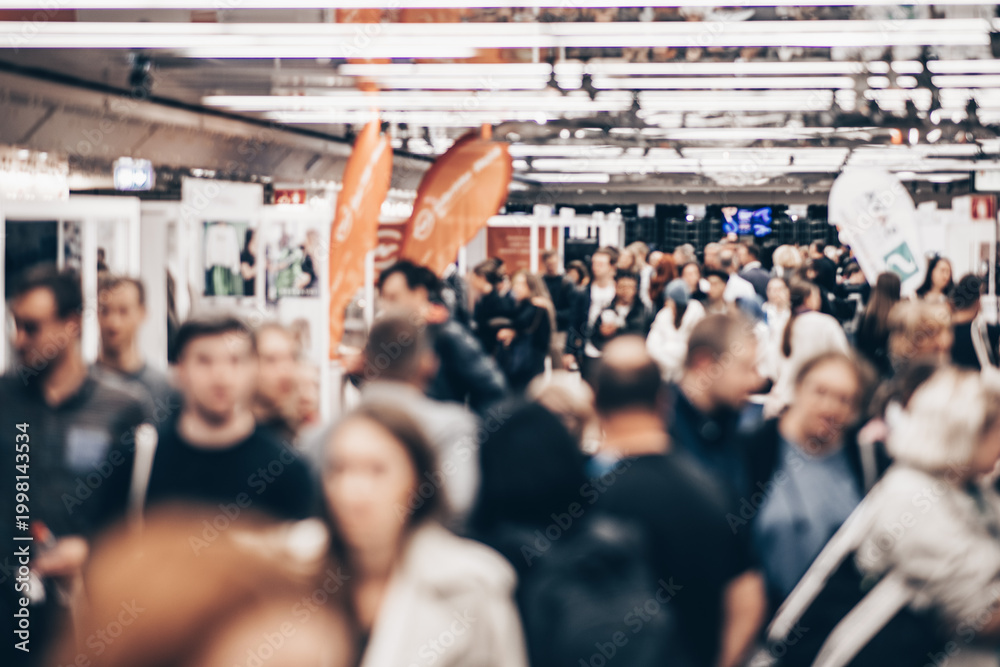 Obraz premium Abstract blurred people at exhibition hall of expo event trade show. Business convention show or job fair. Business concept background