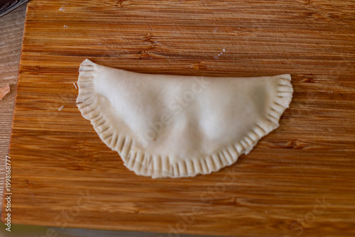 Cooking. Cooking chebureks. Raw meat in dough. A national dish. Cheburek - fried pie with meat and onions. 