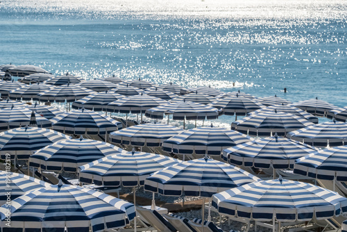 Rows of Blue and White Striped Beach Umbrellas on Nice Coast