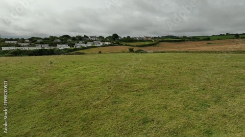 Aerial View of Green Pasture and Traditional Welsh Village on Anglesey Island North Wales
