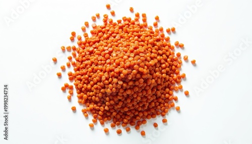 Heap of red lentils scattered on white studio background. Small round uncooked grains offer healthy protein and fiber for cooking vegan and vegetarian meals. Simple food staple.