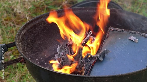 Burning Book on Barbecue Grill Close Up