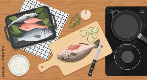 Overhead flat lay of a kitchen counter prepared for cooking fish, with fresh raw seafood, a cutting board, a knife, and an induction stove.
