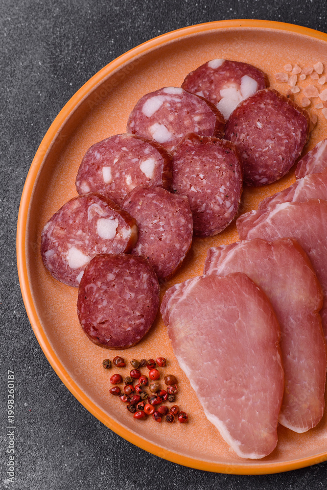 Obraz premium Smoked or dry cured salami slices or ham with salt and spices. Smoked sausage