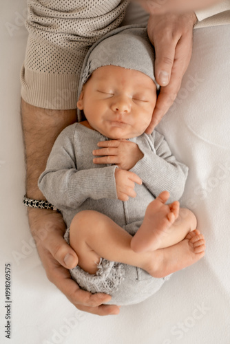 newborn baby in dad's arms, happy single father, young family with baby, fatherhood, father with infant.
