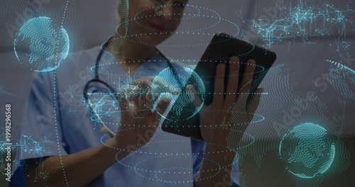 Tapping tablet clinician in light blue scrubs with stethoscope in clinic, viewing holograms