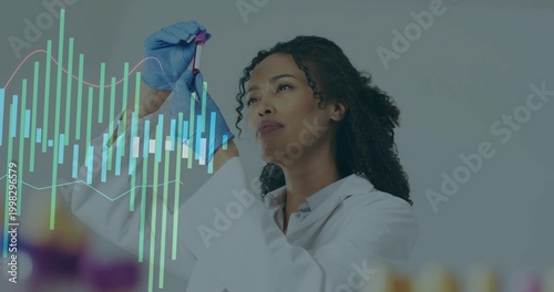 Examining scientist in white coat, blue gloves holding purple cap tube at lab bench, with graphs