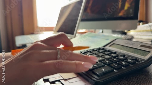 Woman accountant is counting on calculator. closeup