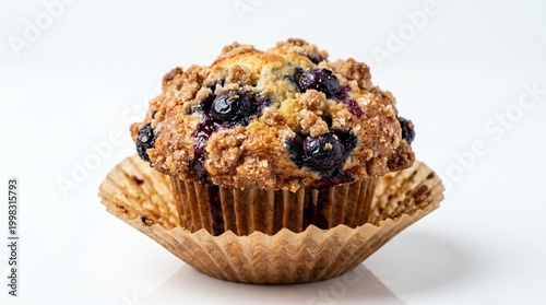 Fresh baked blueberry muffin with sugar crumble topping isolated on white