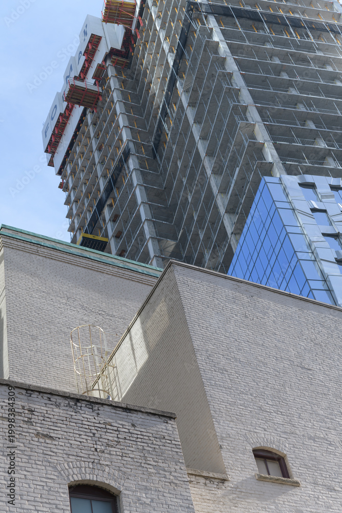 Fototapeta premium historic brick building (rear of Royal Alexandra Theatre, located at 260 King St W, and FORMA condos slight view of 