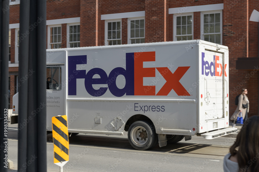 Fototapeta premium FedEx Express delivery truck heading east on Adelaide St W, Toronto