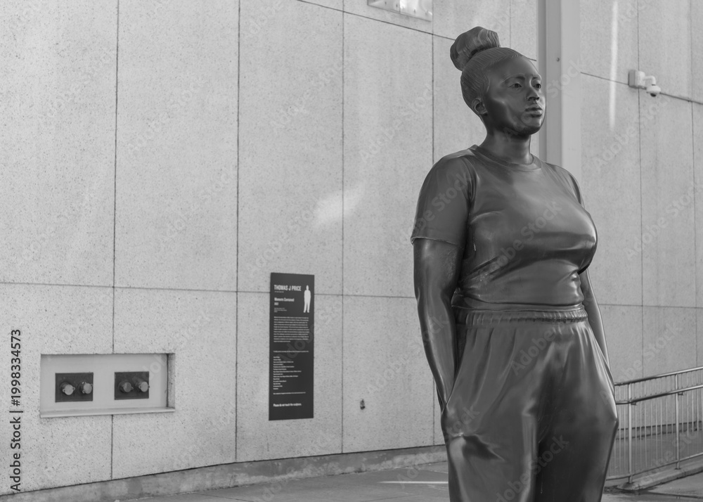 Fototapeta premium black and white view of a young black woman statue by Thomas J Price called 