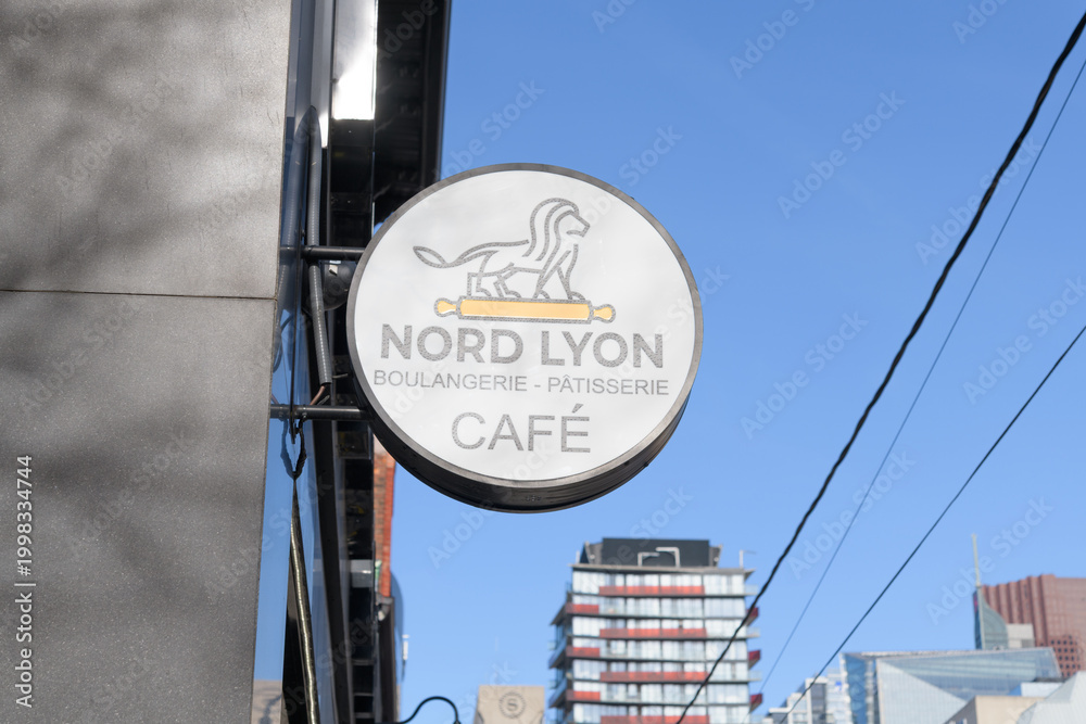 Fototapeta premium sign outside Nord Lyon, a bakery, located at 250 Queen St W, Toronto