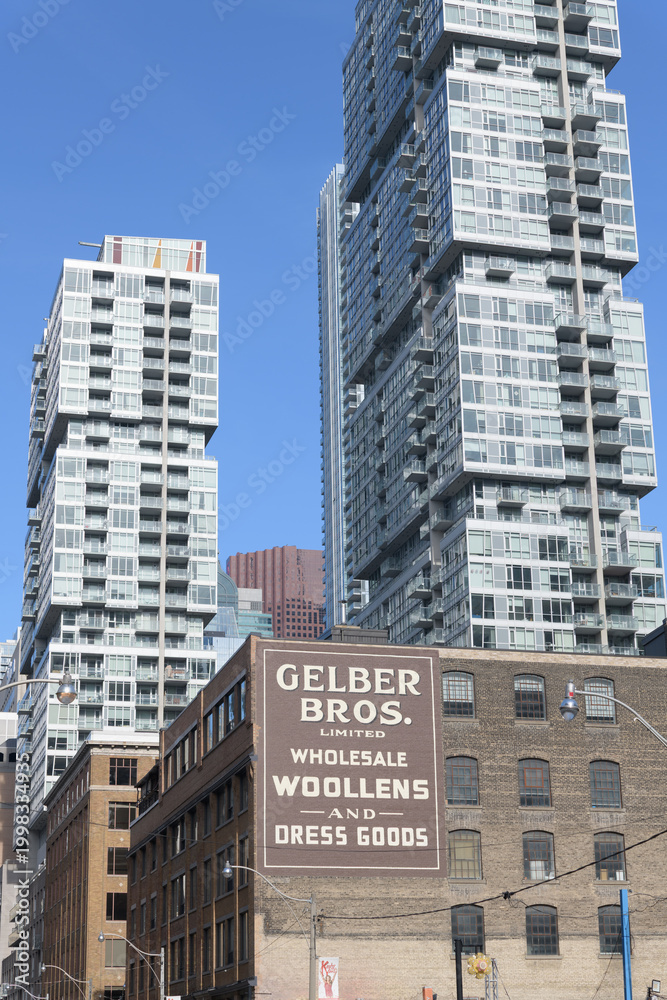 Fototapeta premium restored ghost sign of Gelber Bros. Limited: Wholesale Woollens and Dress Goods located on the west-facing wall of 217-225 Richmond St W, Toronto