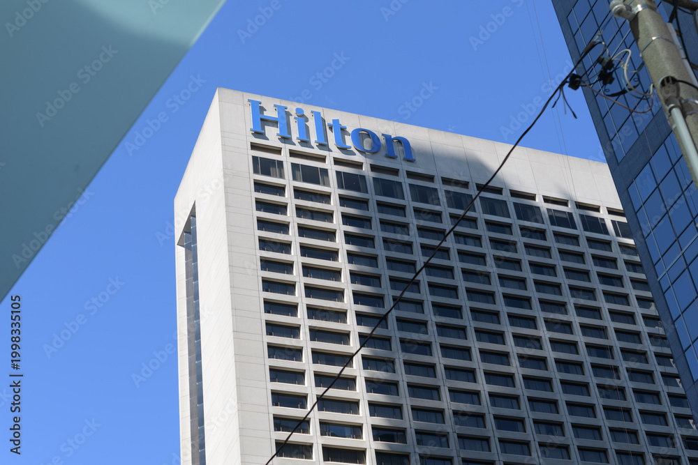 Fototapeta premium sign atop Hilton Toronto, a hotel, located at 145 Richmond St W, viewed from University Av