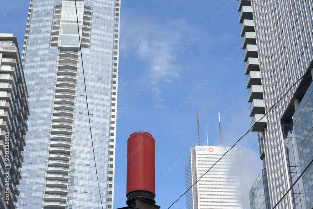 Naklejka premium remnant red can and buildings (left) west elevation of Shangri-La hotel and BMO Group sign at First Canadian Place, Toronto