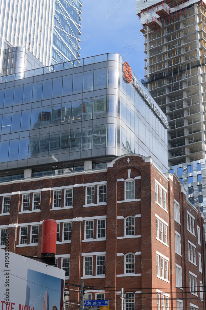 Obraz premium exterior of 19 Duncan, designed by Hariri Pontarini Architects - mixed-use integration of the heritage Southam Press Building and a modern 58-storey tower, housing Thomson Reuters offices