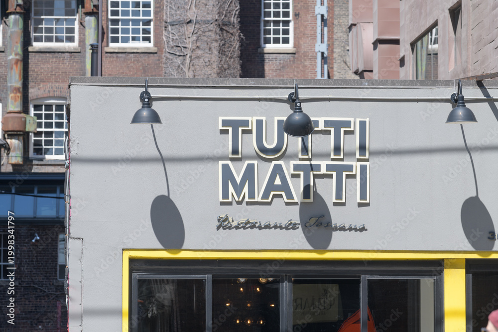 Obraz premium exterior facade and sign of Tutti Matti, a Tuscan restaurant, located at 364 Adelaide St W, Toronto
