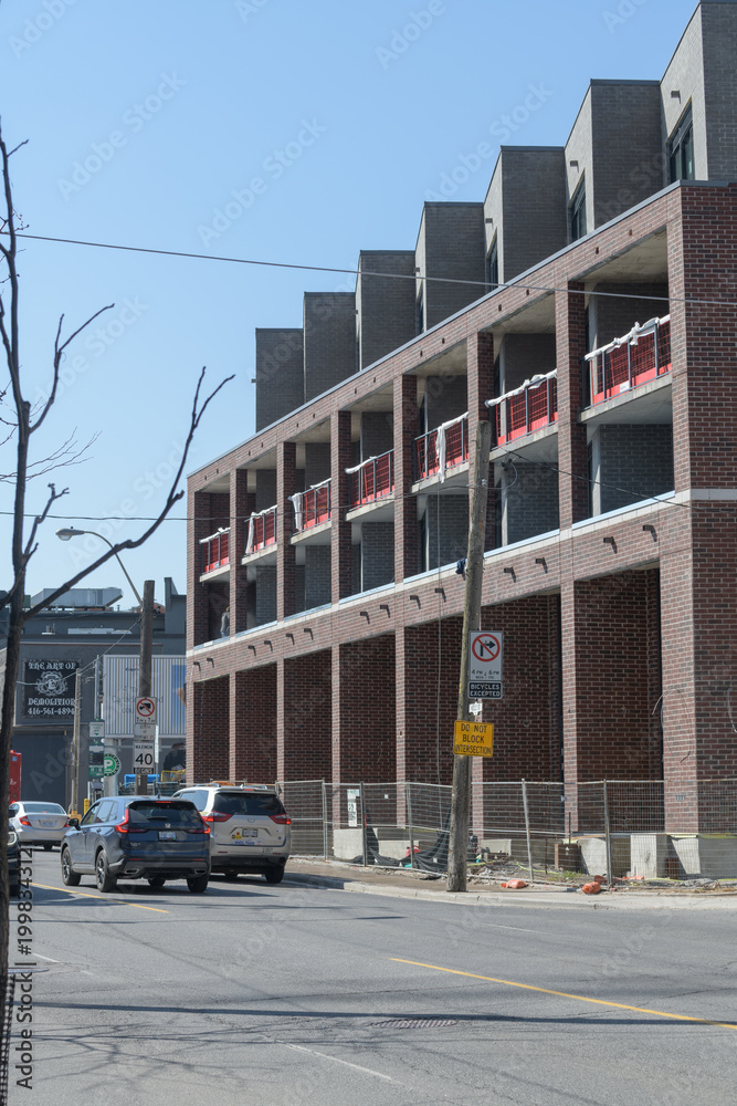 Fototapeta premium perspective view of Junction SQ, a low-rise residential block, by Block Developments, designed by RAW Architects, located at 410 Keele St, The Junction, Toronto
