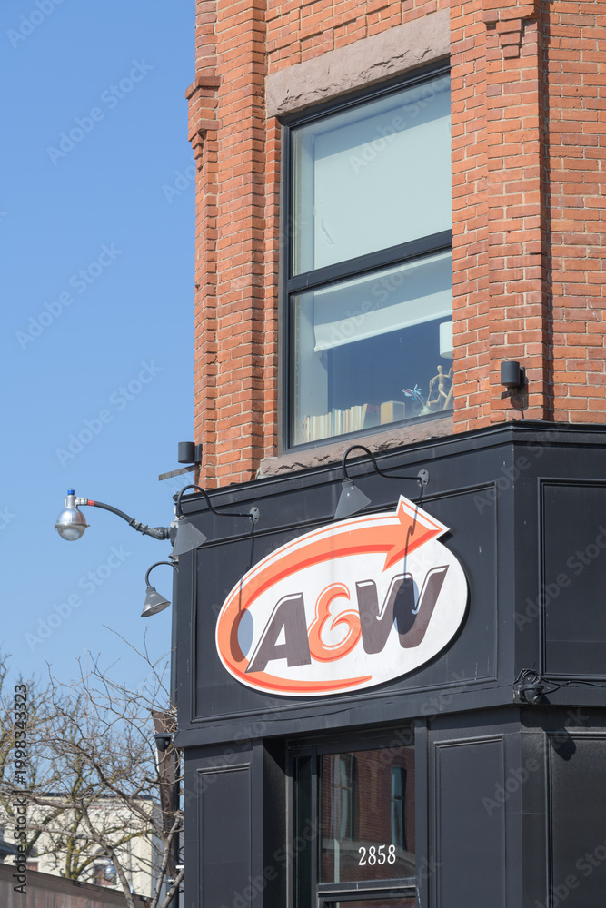 Fototapeta premium exterior building and sign of A&W Canada, a hamburger restaurant chain, located here at 2858 Dundas St W (northwest corner) in historic Campbell Block, The Junction, Toronto