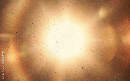 Vintage film texture with dust and scratches on a warm glowing background