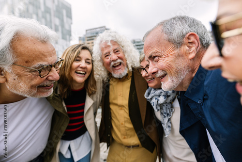 Canvas Print Diverse group of senior friends laughing and enjoying outdoor city moments, shar
