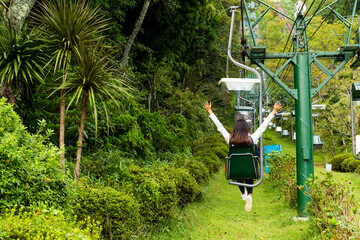 Travel woman riding cable car up mountain for sightseeing